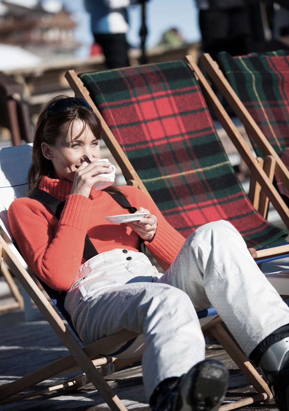 Woman drinking a cup of coffee in ski gear